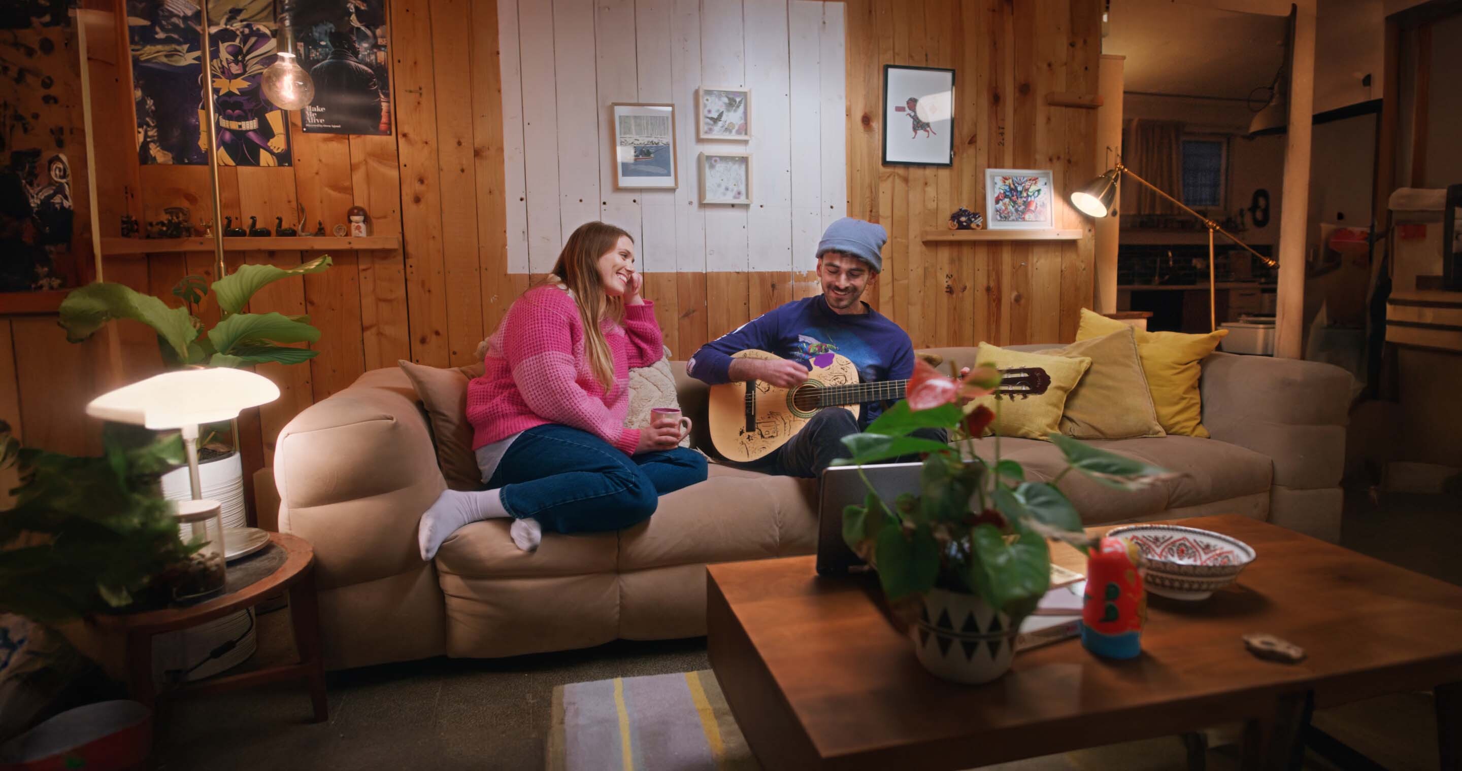 A guy playing the guitar and laughing