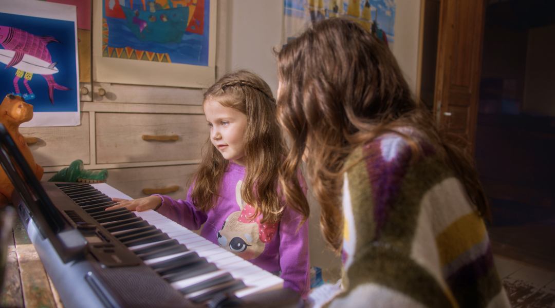 Child enjoying learning piano on a tablet with Simply Piano, one of the best piano applications for kids