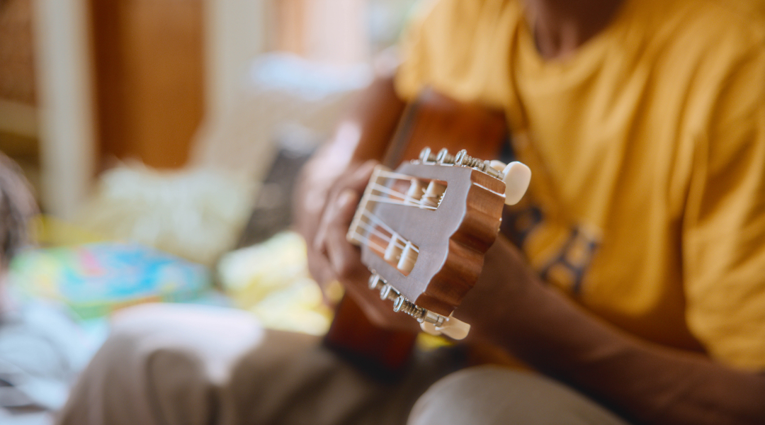 Beginner guitarist learning to play easy songs using guitar tabs with the Simply Guitar app